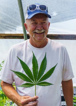Jeff Garland checks on hemp growing in a high tunnel at Papa G’s Organic Hemp Farm in Crawford County, IN June 23, 2022