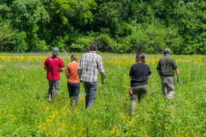 Chris Fox, Sycamore Land Trust land stewardship director, (left) tours Fix-Stoelting Nature Preserve in Bean Blossom Township, Indiana May 26, 2023 along with Allison Shoaf, district conservationist with USDA’s Natural resources Conservation Service, Chris Erickson, Sycamore Land Trust land preservation director, Sara Carter, an intern with Sycamore Land Trust, and John Lawrence, Sycamore Land Trust executive director.