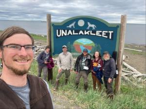 Alaska field staff by the Unalakleet sign.