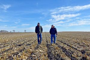 NRCS District Conservationist Josiah Olson (left) talks to Winnebago County farm Mark Kingland about his experience with strip-till farming.
