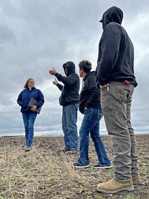 The Rooneys discuss their soils with NRCS District Conservationist Lissa Tschirgi (left).