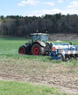 Farm machinery - planter - moving through agricultural field
