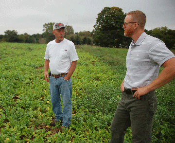 Traverse City-area farmer Dan Hall (left) and NRCS District Conservationist Jason Kimbrough look over a field planted with a mixture of cover crops.