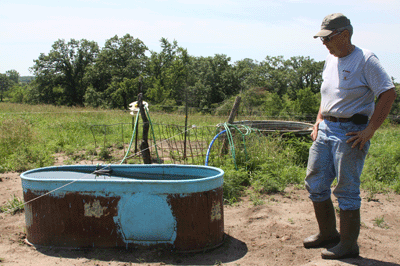 Bedford Farmer Paul Ackley checks his cattle watering tank.