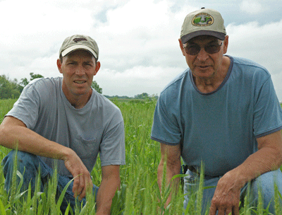 Son Jason Wells, left, influenced his dad Paul, right, to transition to certified organic production.