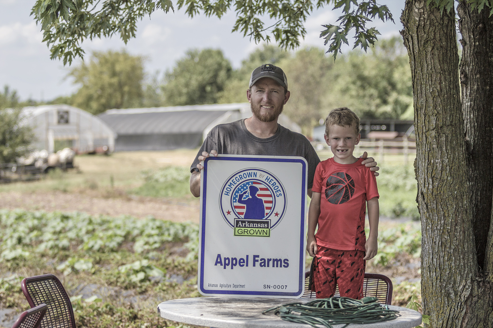 Travis Appel, pictured with his son Griffin, at his farm located in Springdale, Ark.